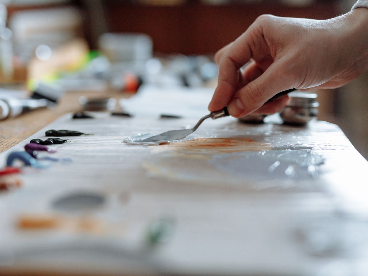 An artist using a palette knife