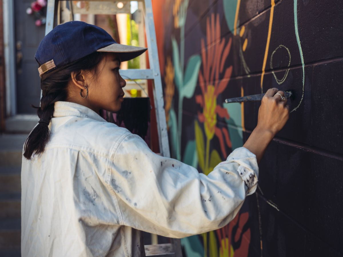 Close-up of mural artist at work