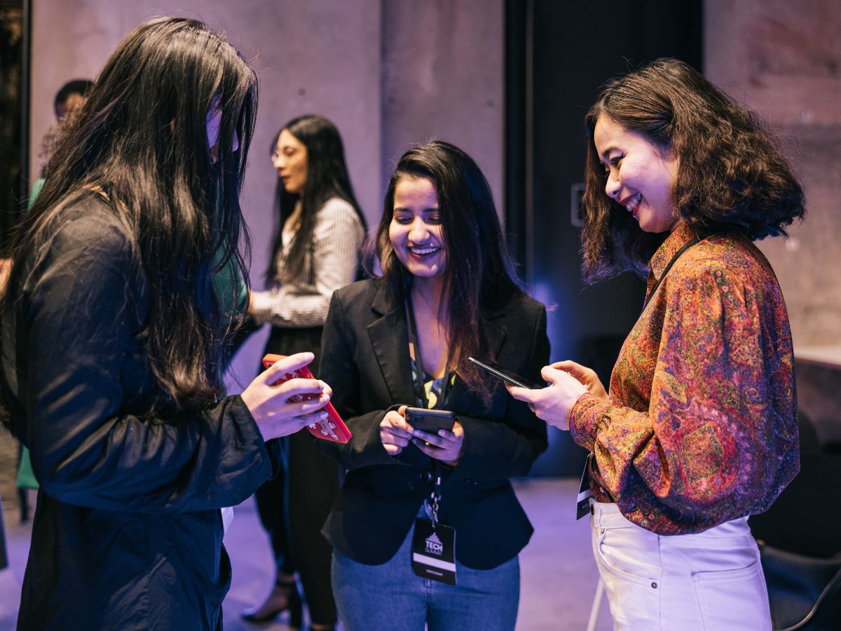 three women at an art event