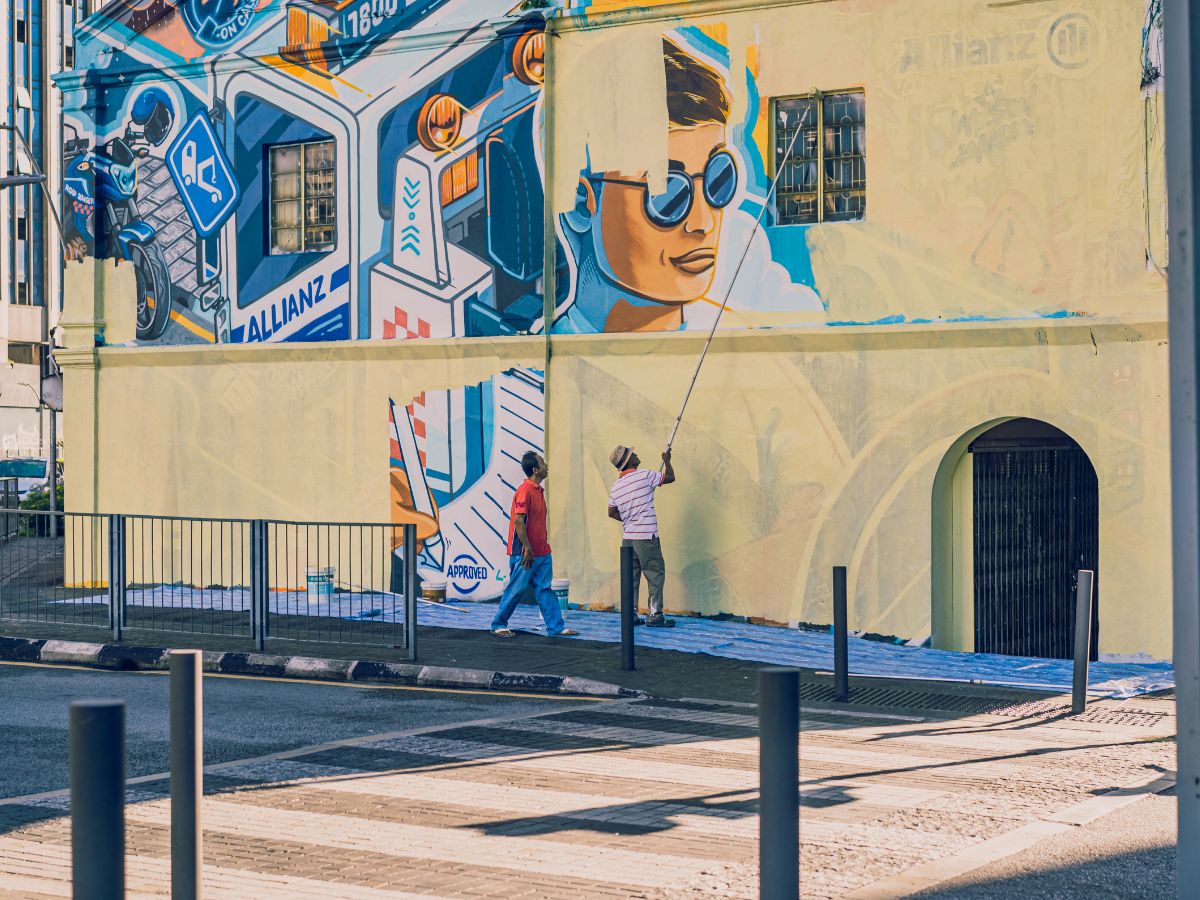 two muralists at work