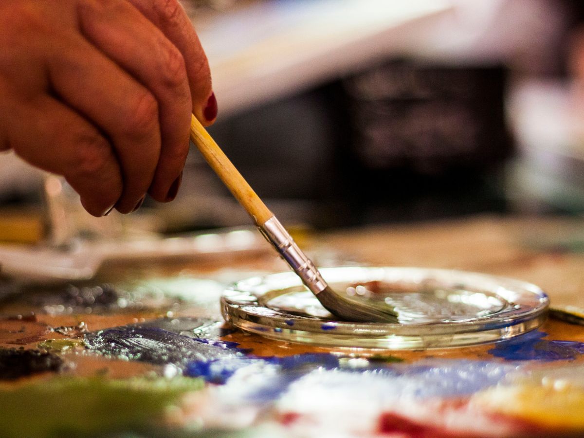 Person Holding Brown and Gray Paint Brush