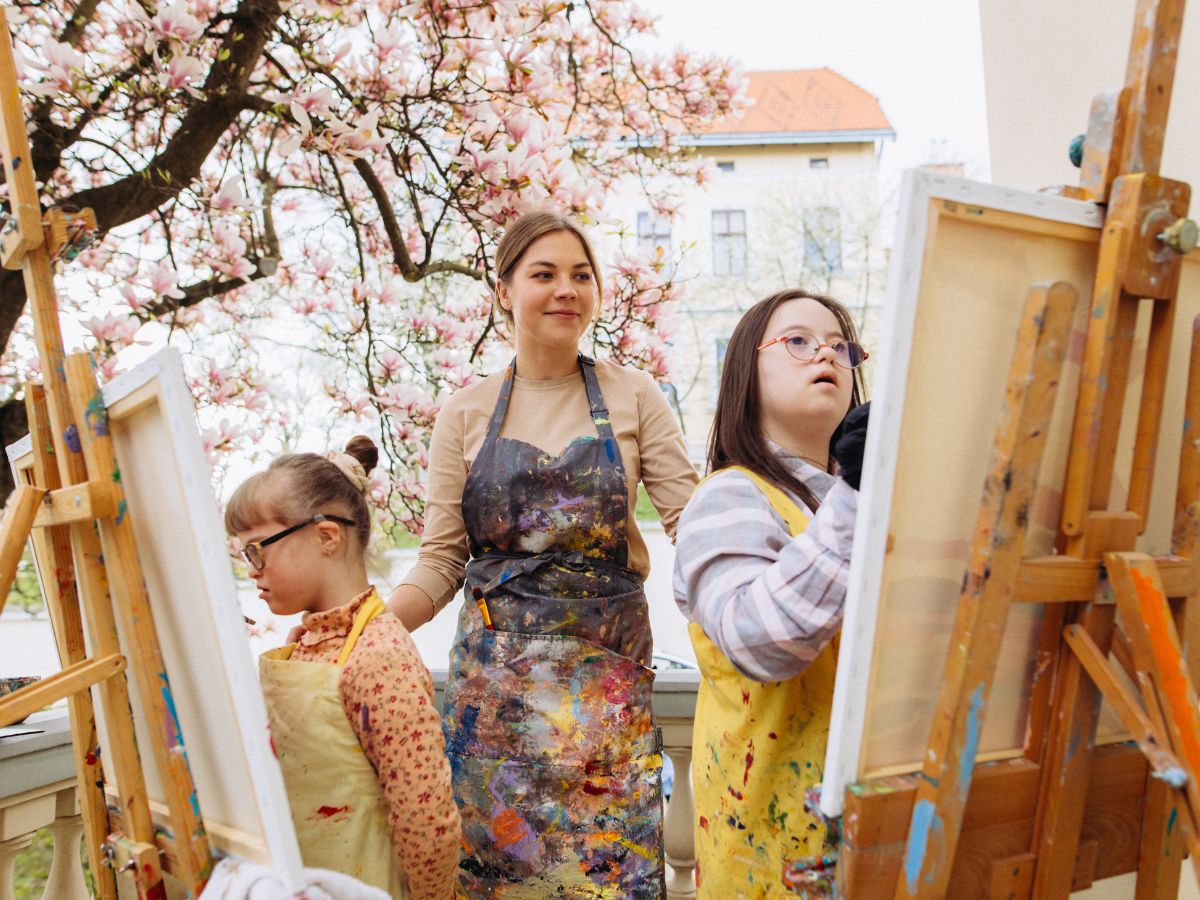 canvas painting at art therapy of two girls with mental disability
