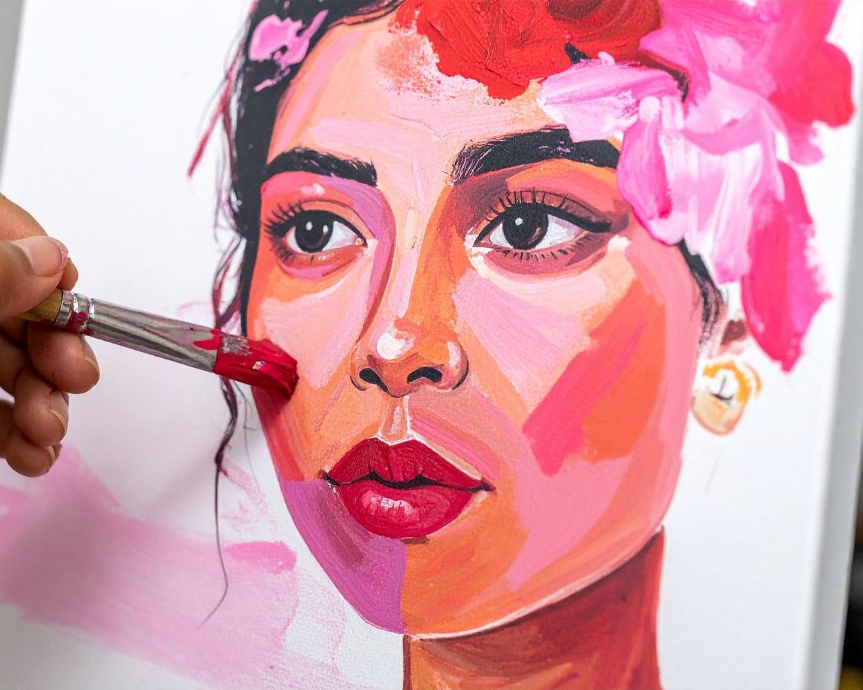 artist painting a woman's portrait using acrylic paint
