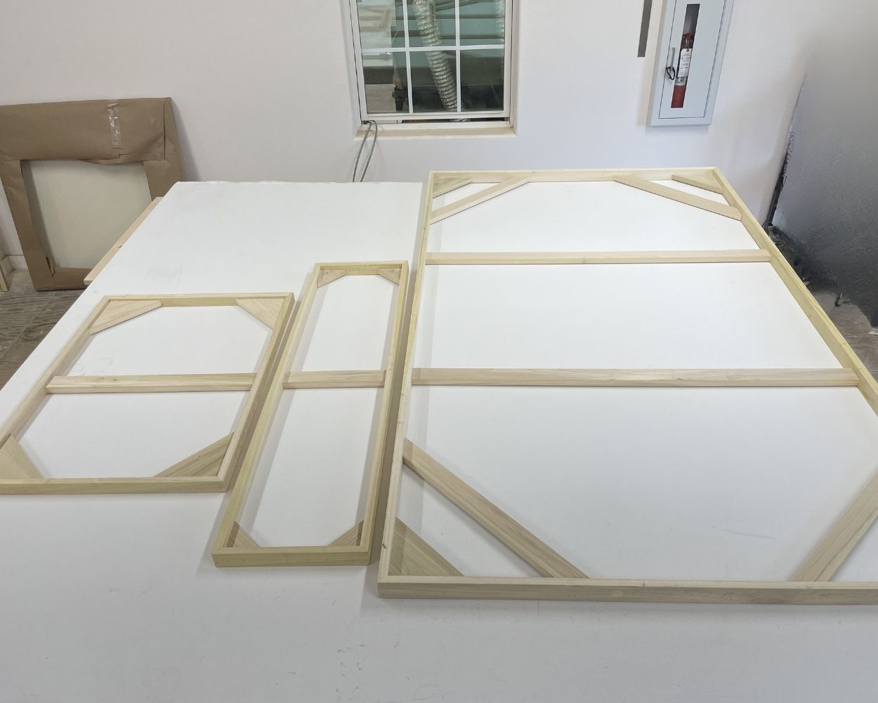 stretcher bars at the back of several canvases