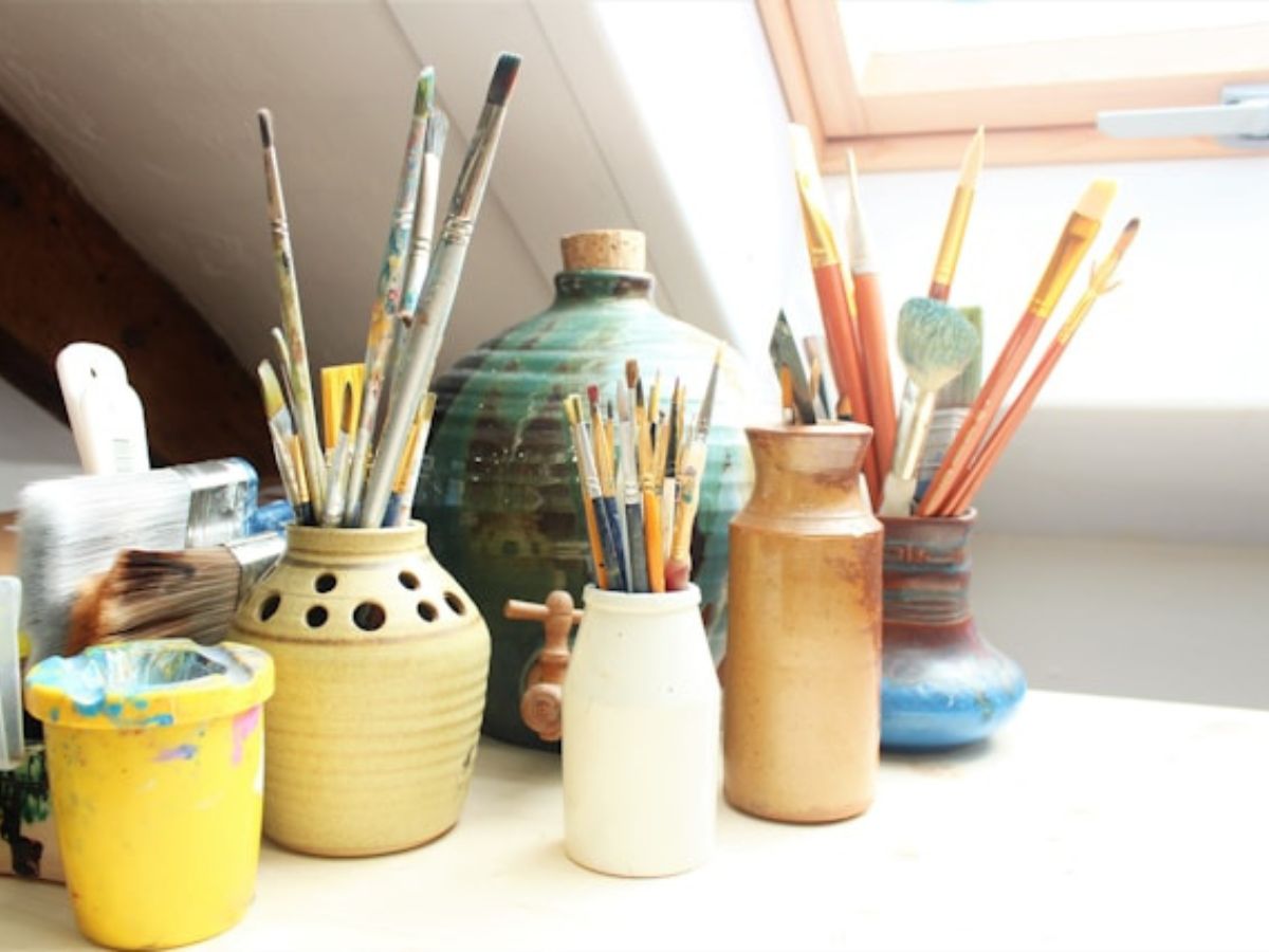 paint brushes on a jar