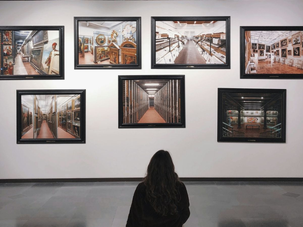Woman viewing paintings in an art gallery