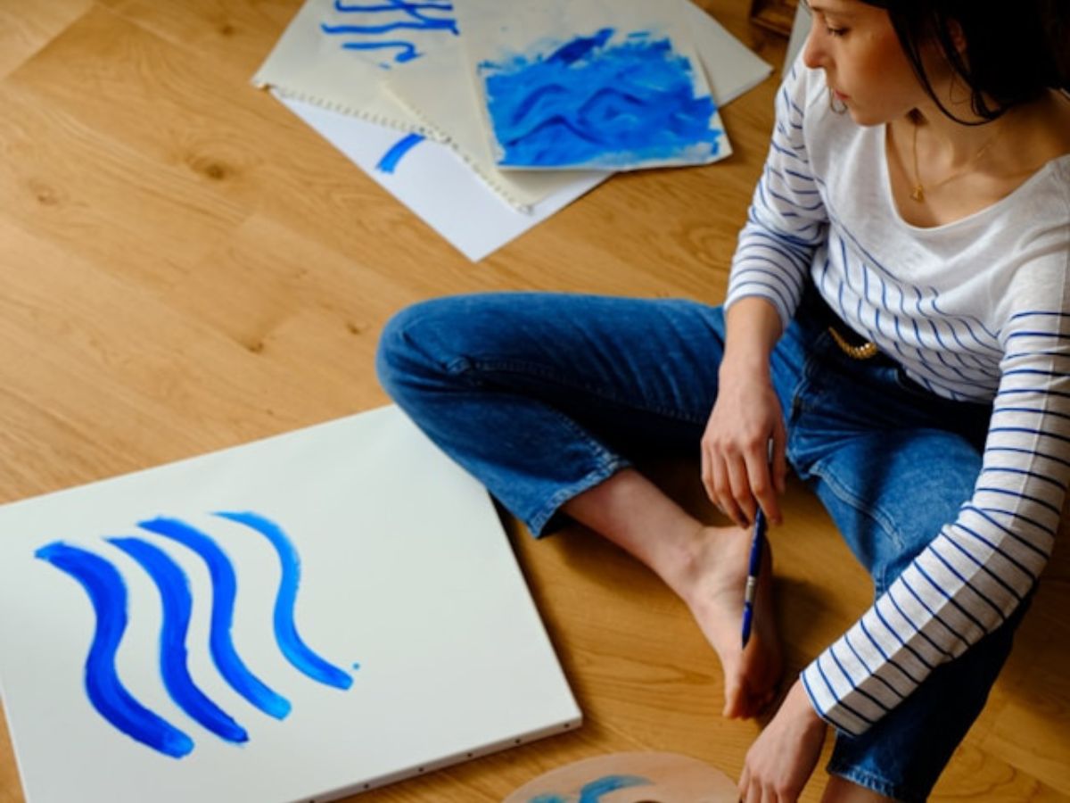 woman painting on the floor