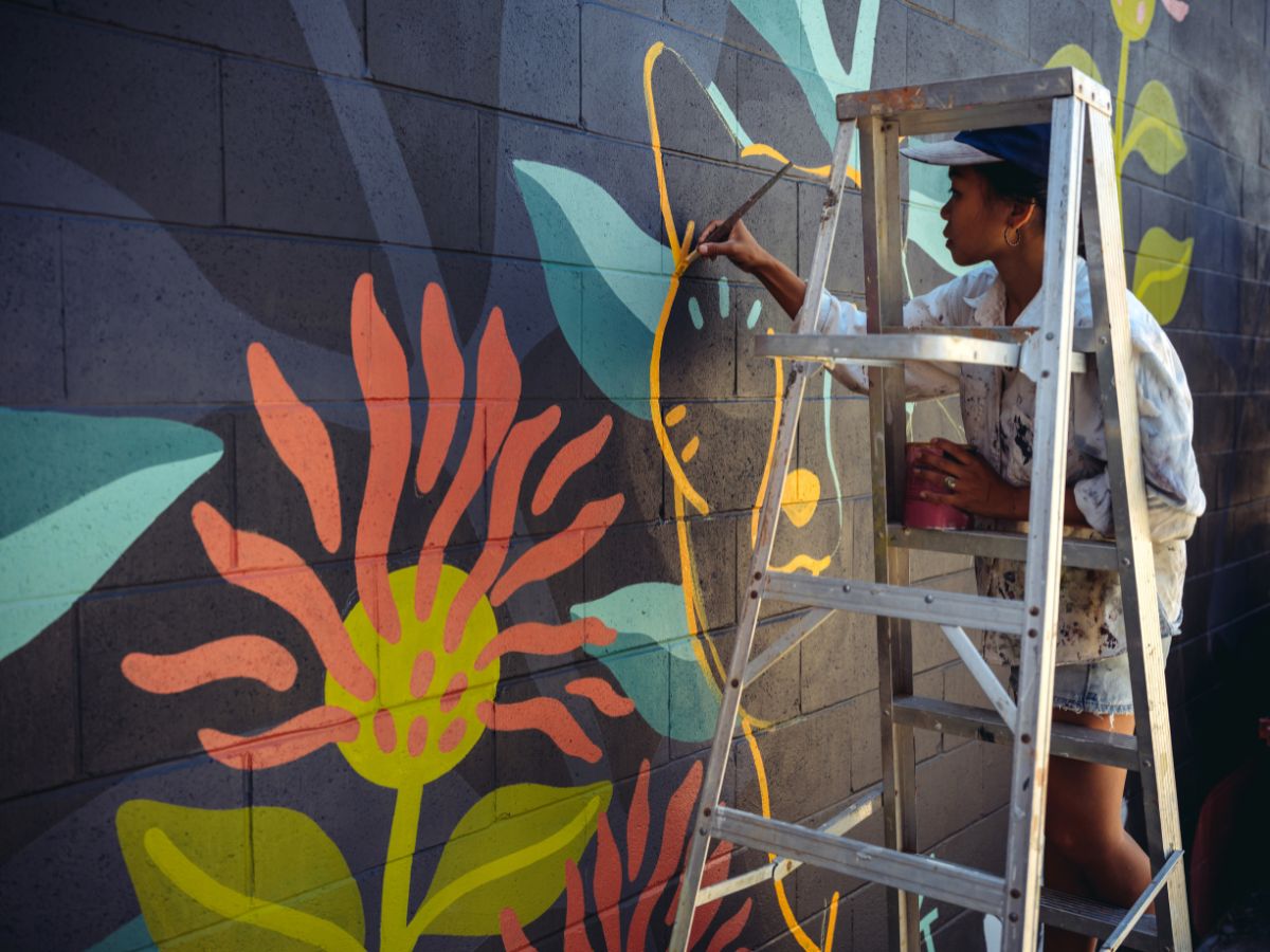 muralist on a ladder