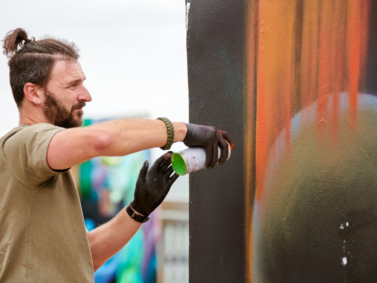 man spraying a mural