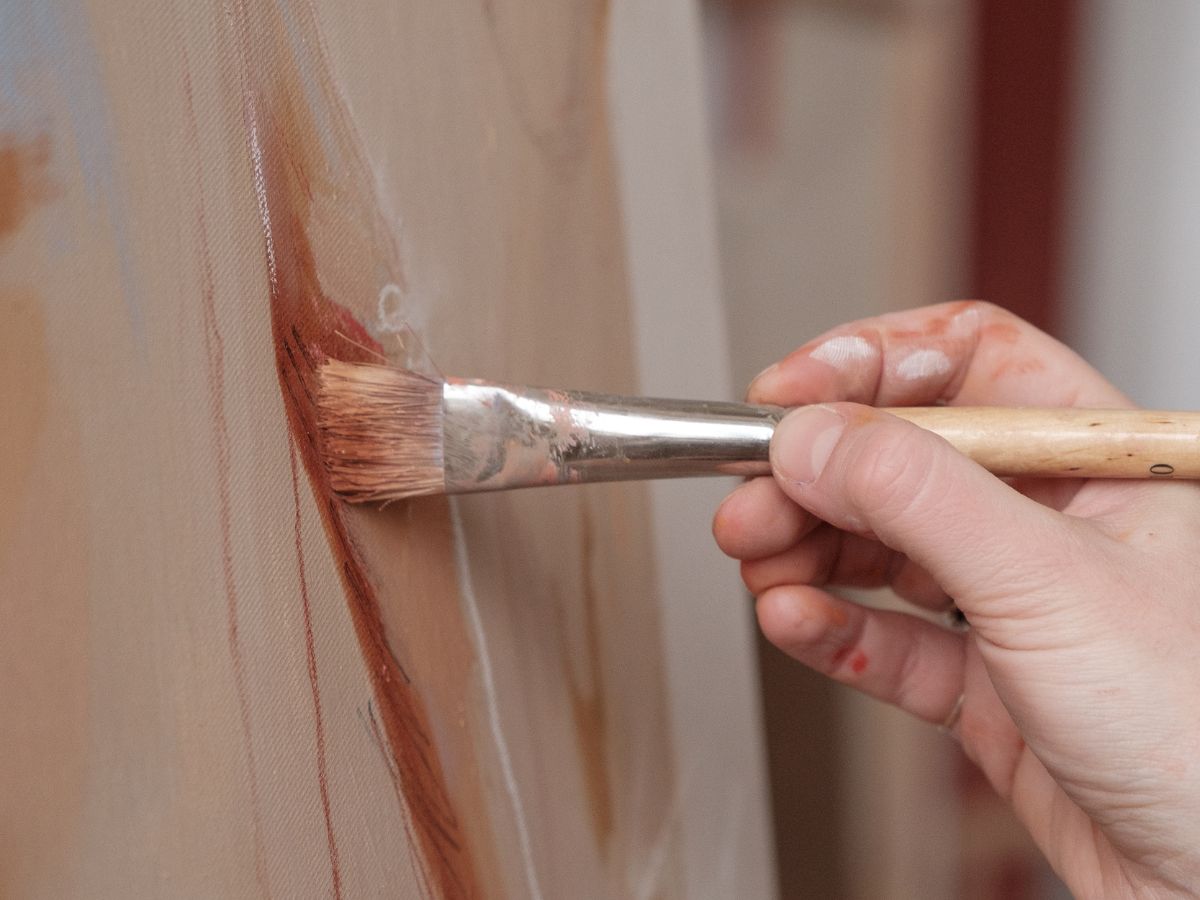 artist painting canvas close-up