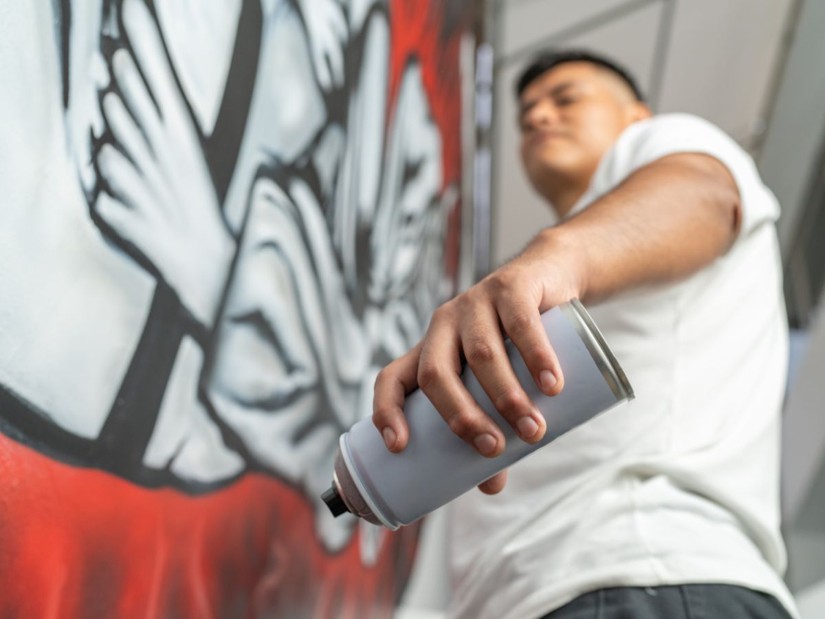 muralist working on urban mural