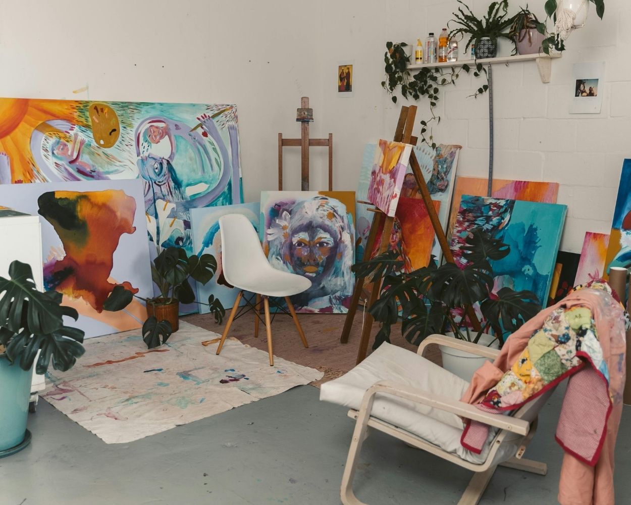 art studio with several paintings on display